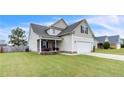 Attractive two-story home with a manicured lawn, covered porch, and an attached garage at 110 Wynngate Dr, Cameron, NC 28326