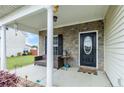 Inviting covered porch with stone accents, comfortable seating, and decorative features at 110 Wynngate Dr, Cameron, NC 28326