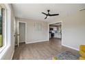 Cozy living room featuring hardwood floors, neutral walls, and an archway leading to the kitchen at 11504 Bissette Rd, Middlesex, NC 27557