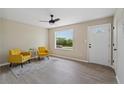 Bright living room featuring hardwood floors, ceiling fan, and large picture window at 11504 Bissette Rd, Middlesex, NC 27557
