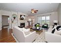 Bright living room with a fireplace, built-in shelves, and hardwood floors at 1222 Waterford Lake Dr, Cary, NC 27519