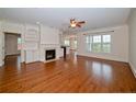 Open living room with hardwood floors, built-in shelves, and a fireplace at 1222 Waterford Lake Dr, Cary, NC 27519