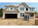 New home construction showing house wrap, windows, and lumber stacked on the construction site at 238 Steeple Ridge, Cameron, NC 28326