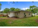 Exterior of the property shows the stone facade and spacious backyard with a gazebo at 255 Chris Cole Rd, Sanford, NC 27332