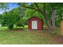 View of the backyard shed surrounded by mature trees at 255 Chris Cole Rd, Sanford, NC 27332