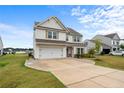 Traditional two-story home with a lush front lawn, two car garage and driveway at 40 Arlie Ln, Lillington, NC 27546