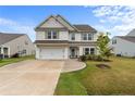 Traditional two-story home with a two car garage and meticulously manicured lawn at 40 Arlie Ln, Lillington, NC 27546