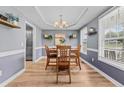 A dining room with wood floors, modern lighting, and a tray ceiling is perfect for Gathering gatherings at 70 Mountainside Ln, Sanford, NC 27332