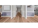 A hallway view with wood-look flooring, and fresh paint, offering a glimpse into the home's layout at 70 Mountainside Ln, Sanford, NC 27332