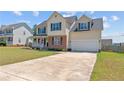 Inviting two-story home with a neat lawn, a spacious driveway, and a welcoming front porch at 106 Polk St, Spring Lake, NC 28390