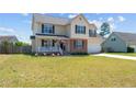 Attractive two-story home with a covered porch, well-kept lawn, and an attached garage at 106 Polk St, Spring Lake, NC 28390