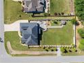An aerial view shows the roof line, backyard patio area, and landscaping at 12 Ballentyne Ct, Sanford, NC 27332