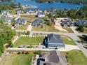 Beautiful aerial view of the property surrounded by mature trees near the lake at 12 Ballentyne Ct, Sanford, NC 27332