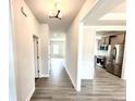 Inviting entryway featuring wood-look flooring, light fixtures, and seamless transition to other living spaces at 122 Southern Estates Dr, Sanford, NC 27330