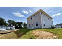 New two-story home with gray siding, situated on a manicured lawn in a residential neighborhood at 211 Drayton Hall Ln, Sanford, NC 27330
