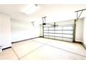 Spacious two-car garage featuring a clean and organized space with a white garage door at 211 Drayton Hall Ln, Sanford, NC 27330