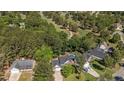 Aerial view of a home with a swimming pool, lush landscaping and a golf course nearby at 227 Carolina Way, Sanford, NC 27332