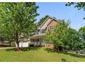 A traditional home with a well-kept lawn and mature trees offers a serene and picturesque setting at 227 Carolina Way, Sanford, NC 27332