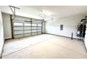 Spacious two car garage featuring concrete floors, white walls, and an automatic door at 324 Bishop Ln, Sanford, NC 27330