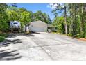 Charming ranch home with a spacious driveway, mature trees, and welcoming front porch at 46 Sherwood Hills Ct, Cameron, NC 28326
