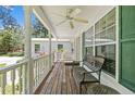 Inviting covered front porch featuring a ceiling fan, ample seating, and beautiful outdoor views at 46 Sherwood Hills Ct, Cameron, NC 28326