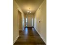 Foyer features hardwood floors and a view of the front door with sidelights at 78 Falls Of The Cape Dr, Lillington, NC 27546
