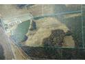 Aerial view of a large property with a pond, fields, and wooded areas, property line highlighted at 1445 Bethel Baptist Rd, Spring Lake, NC 28390