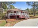 Inviting single-story home with a red facade, white trim, and a welcoming front porch at 201 Sierra Trl, Spring Lake, NC 28390