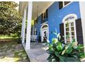 Inviting front porch with white columns and rocking chairs, perfect for relaxing outdoors at 236 E Andrews Ave, Henderson, NC 27536