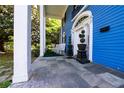 Charming porch with stone flooring, adorned with rocking chairs and decorative plants at 236 E Andrews Ave, Henderson, NC 27536