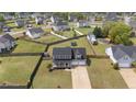 Aerial view of a two-story home with a large backyard, two-car garage, and well-kept landscaping at 352 Asheford Way, Cameron, NC 28326