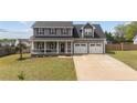 Charming two-story home with a covered front porch and a two-car garage at 352 Asheford Way, Cameron, NC 28326
