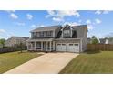 Inviting two-story home featuring a covered front porch, two-car garage, and well-maintained landscaping at 352 Asheford Way, Cameron, NC 28326