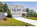 Charming two-story home featuring a well-manicured lawn and a long driveway at 45 William Bethune Ct, Linden, NC 28356