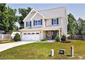Charming two-story home with a well-manicured lawn and a long driveway at 45 William Bethune Ct, Linden, NC 28356