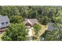 Overhead shot of brick home featuring mature trees, backyard, and neighborhood at 481 Clearwater Hbr, Sanford, NC 27332