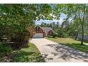 Inviting brick home with a two car garage, surrounded by mature trees and a well-maintained lawn at 481 Clearwater Hbr, Sanford, NC 27332