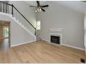 Bright living room boasts a vaulted ceiling, fireplace, and natural light, creating a cozy atmosphere at 4916 Royal Adelaide Way, Raleigh, NC 27604