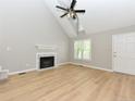 Light-filled living room features a fireplace, wood floors, and neutral paint, perfect for entertaining at 4916 Royal Adelaide Way, Raleigh, NC 27604