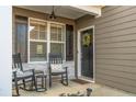 Cozy front porch features rocking chairs, providing a relaxing outdoor space at the home's entry at 74 Spruce Hollow Cir, Spring Lake, NC 28390