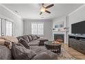 Comfortable living room boasts a fireplace, large TV, and cozy sectional sofa at 74 Spruce Hollow Cir, Spring Lake, NC 28390