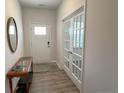 Bright foyer with a view of the front door, leading to an office with elegant french doors at 158 David Hill Dr, Sanford, NC 27330