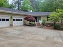 Well-maintained ranch home with attached two-car garage and landscaped front yard, featuring a brick-lined entry walkway at 179A Fairway Ln, Sanford, NC 27332