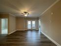 Open-concept living room featuring hard surface floors, neutral walls and access to an outdoor balcony at 240 Gallery Dr # 203, Spring Lake, NC 28390