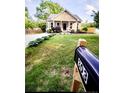 Quaint single-story house with a manicured lawn, mailbox, and lush green landscaping around the property at 303 Tanglewood Dr, Louisburg, NC 27549