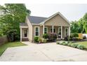 Attractive home featuring a spacious driveway, lush lawn, and an inviting front entrance at 303 Tanglewood Dr, Louisburg, NC 27549