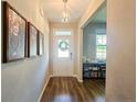 Welcoming entryway with hardwood floors, a front door with glass, and a view into the living spaces at 334 Bunting Dr, Lillington, NC 27546