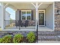 Charming front porch showcasing stone accents, black railings, and a welcoming entrance at 334 Bunting Dr, Lillington, NC 27546