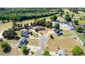 Expansive aerial view of a residential area showcasing multiple homes, golf course, and a neighborhood pool at 390 Sandy Ridge Rd, Dunn, NC 28334
