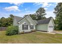 Single story home with light green horizontal siding, manicured front lawn, and black shutters at 708 Overhills Rd, Linden, NC 28356